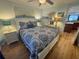 Well-lit bedroom with a comfortable bed and view into an adjacent room at 280 Driftwood Ln, Edisto Beach, SC 29438