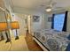 Well-lit bedroom with a comfortable bed and view into an adjacent room at 280 Driftwood Ln, Edisto Beach, SC 29438