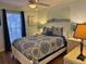 Comfortable bedroom with a queen bed, ceiling fan, and bright window at 280 Driftwood Ln, Edisto Beach, SC 29438
