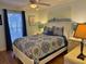 Comfortable bedroom with a queen bed, ceiling fan, and bright window at 280 Driftwood Ln, Edisto Beach, SC 29438