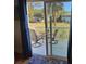 View from a cozy deck of a home with outdoor seating and views of the surrounding greenery at 280 Driftwood Ln, Edisto Beach, SC 29438