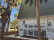 Exterior view of condo with white siding, wooden fence, and large palm trees at 280 Driftwood Ln, Edisto Beach, SC 29438