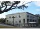 Commercial building with ample windows, well-maintained landscaping, and golf cart parking at 280 Driftwood Ln, Edisto Beach, SC 29438
