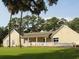 Charming home with a spacious porch and a lush green lawn, great for entertaining at 280 Driftwood Ln, Edisto Beach, SC 29438