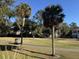 Scenic golf course view with lush greenery and palm trees under a clear blue sky at 280 Driftwood Ln, Edisto Beach, SC 29438