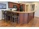 Spacious kitchen with bar seating, hardwood floors, and views into the dining area at 280 Driftwood Ln, Edisto Beach, SC 29438