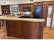 Well-equipped kitchen with dark cabinets, island counter, and modern appliances at 280 Driftwood Ln, Edisto Beach, SC 29438