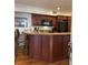 Open kitchen area with wooden cabinets, countertops, a microwave, and a black refrigerator at 280 Driftwood Ln, Edisto Beach, SC 29438
