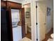 Kitchen with built in washer and dryer combo and bathroom access at 280 Driftwood Ln, Edisto Beach, SC 29438