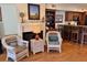 Cozy living space with wicker chairs, wooden floors, and a view into the kitchen at 280 Driftwood Ln, Edisto Beach, SC 29438