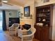 Open concept living area featuring light walls, hardwood floors, wicker chairs, and custom cabinetry at 280 Driftwood Ln, Edisto Beach, SC 29438