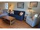 Comfortable living area with a blue sofa, patterned chair, and natural light at 280 Driftwood Ln, Edisto Beach, SC 29438