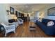 Cozy living room with wood floors, ceiling fan, fireplace, and comfortable seating area at 280 Driftwood Ln, Edisto Beach, SC 29438