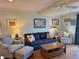 Cozy living room with soft blue walls, comfortable seating, and hardwood floors at 280 Driftwood Ln, Edisto Beach, SC 29438