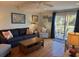 Cozy living room featuring a comfortable sofa, armchair, and access to outdoor deck at 280 Driftwood Ln, Edisto Beach, SC 29438