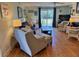 Bright living room with a sofa, two wicker chairs, a coffee table, and hardwood floors at 280 Driftwood Ln, Edisto Beach, SC 29438