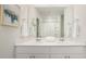 Elegant bathroom featuring a double sink vanity with a large mirror, decorative art, and fluffy white towels at 306 Pine Crest View Dr, Summerville, SC 29486
