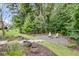 A cozy backyard seating area with an inviting fire pit and mature trees at 331 Weston Hall Dr, Summerville, SC 29483