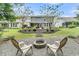 Large backyard including a fire pit, seating, a patio, and a screened in porch at 331 Weston Hall Dr, Summerville, SC 29483