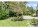 A lush backyard features a stone patio, a fire pit, and established landscaping at 331 Weston Hall Dr, Summerville, SC 29483