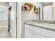 Well-lit bathroom featuring a granite countertop, modern sink, and decorative wooden shelves at 331 Weston Hall Dr, Summerville, SC 29483