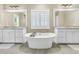 Luxurious bathroom with a standalone soaking tub, dual vanities, and stylish white cabinets at 331 Weston Hall Dr, Summerville, SC 29483