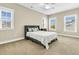 Bright bedroom with neutral walls and three windows offering natural light and neighborhood views at 331 Weston Hall Dr, Summerville, SC 29483