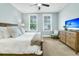 Bright bedroom with carpet, pale blue walls, neutral bedding, and two windows with shutter-style blinds at 331 Weston Hall Dr, Summerville, SC 29483