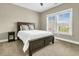 Comfortable bedroom with a dark wood bed frame, neutral walls, and natural light at 331 Weston Hall Dr, Summerville, SC 29483