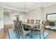 A dining room features a wood table, seating for eight, and a blue patterned area rug at 331 Weston Hall Dr, Summerville, SC 29483