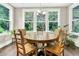 Charming dining room with a round wood table and views of the green landscape at 331 Weston Hall Dr, Summerville, SC 29483