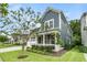 Charming two-story home featuring a stone facade, blue siding, and a well-manicured lawn at 331 Weston Hall Dr, Summerville, SC 29483