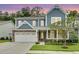 Charming two-story home featuring a stone facade, blue siding, and a well-manicured lawn at 331 Weston Hall Dr, Summerville, SC 29483