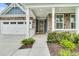Inviting front porch with stone accents, white columns, and well-maintained landscaping at 331 Weston Hall Dr, Summerville, SC 29483