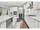 A modern kitchen features white cabinets, stainless steel appliances, and stone countertops at 331 Weston Hall Dr, Summerville, SC 29483