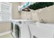 Bright laundry room with modern washer and dryer, a utility sink, and ample storage space at 331 Weston Hall Dr, Summerville, SC 29483