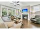 Cozy living room with a fireplace, hardwood floors, and large windows that provide plenty of natural light at 331 Weston Hall Dr, Summerville, SC 29483