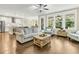 Open-concept living room with hardwood floors, neutral decor, and large windows overlooking the backyard at 331 Weston Hall Dr, Summerville, SC 29483