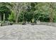 Outdoor stone patio with elegant furniture and lush greenery, creating a serene and inviting space at 331 Weston Hall Dr, Summerville, SC 29483