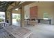 Spacious outdoor patio with a brick fireplace and wooden picnic tables for gatherings and entertaining at 331 Weston Hall Dr, Summerville, SC 29483