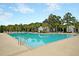 Inviting community pool surrounded by lush landscaping, providing a refreshing escape for residents at 331 Weston Hall Dr, Summerville, SC 29483