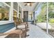 Inviting screened porch with comfortable rocking chairs and stylish patterned flooring, ideal for outdoor living at 331 Weston Hall Dr, Summerville, SC 29483