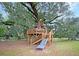 Elaborate treehouse featuring multiple levels, decks, and a slide, offering a fun outdoor play area at 331 Weston Hall Dr, Summerville, SC 29483