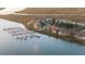 Scenic aerial view of waterfront real estate with a marina and beautiful views at 46 Mariners Cay Dr, Folly Beach, SC 29439
