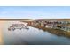 Scenic aerial shot of waterfront condo community with boat docks, set against expansive marshland at 46 Mariners Cay Dr, Folly Beach, SC 29439