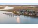 Stunning aerial showcasing waterfront condos next to serene marsh views and boat docks at 46 Mariners Cay Dr, Folly Beach, SC 29439