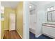 Bright hallway leading to a well-lit bathroom with tiled floors and modern fixtures at 46 Mariners Cay Dr, Folly Beach, SC 29439