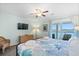 Serene bedroom with waterfront view, a TV, and nautical-themed bedding at 46 Mariners Cay Dr, Folly Beach, SC 29439