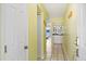Bright foyer with tile flooring, coat closet, and view of the wet bar and living area with water views at 46 Mariners Cay Dr, Folly Beach, SC 29439