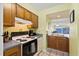 Cozy kitchen offering essential appliances, practical counter space, and an open view into the bright living area at 46 Mariners Cay Dr, Folly Beach, SC 29439